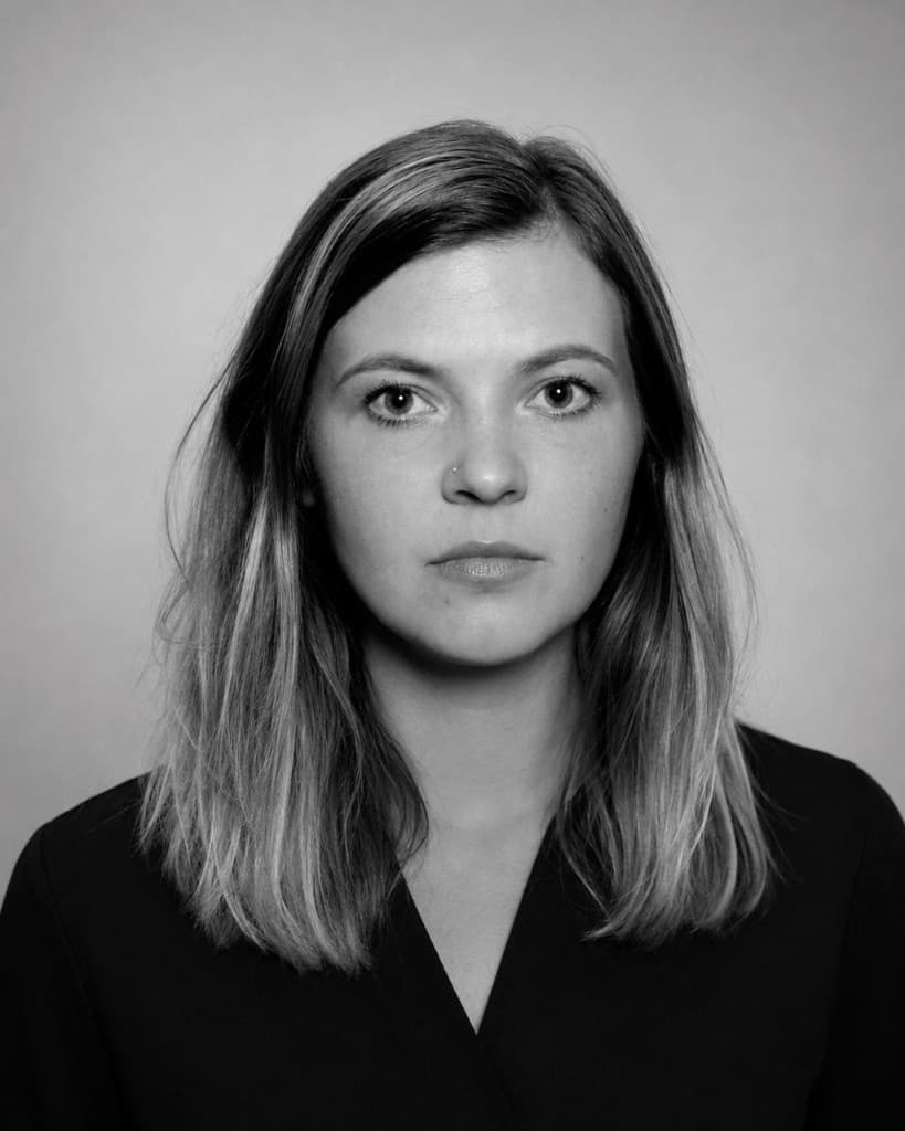 Black-and-white studio portrait of Nataliaki looking directly at the camera.